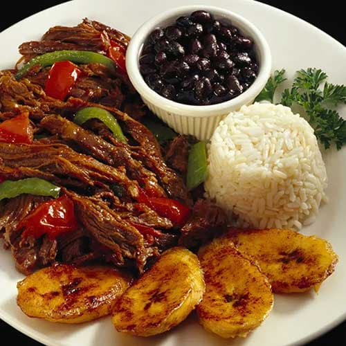 Cuban ropa vieja with black beans, rice and plantains