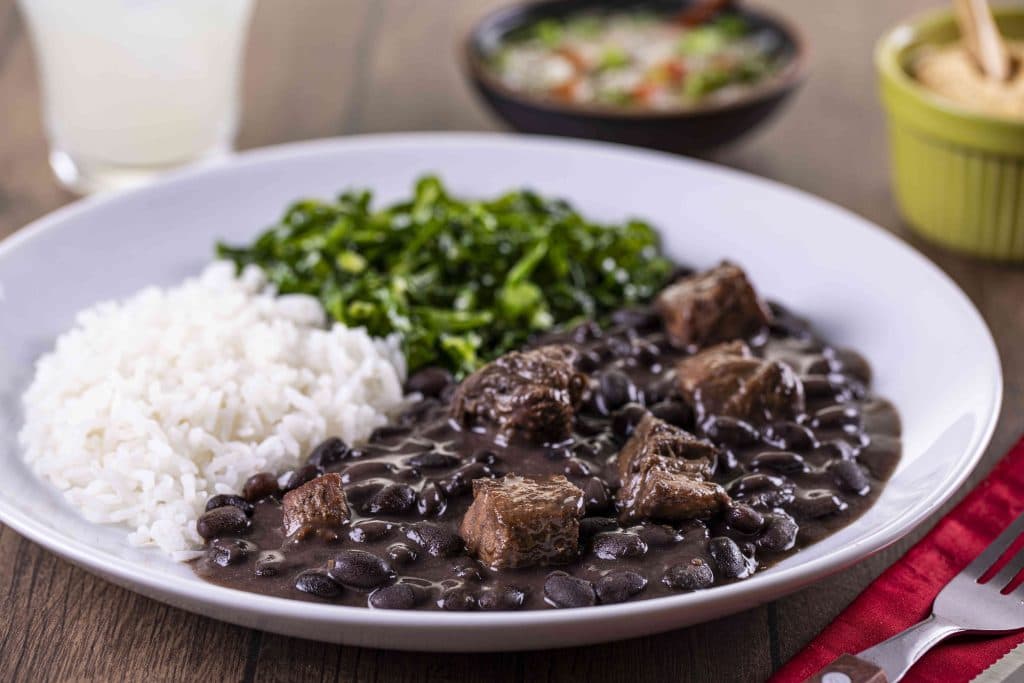 Brazilian feijoada with rice and greens